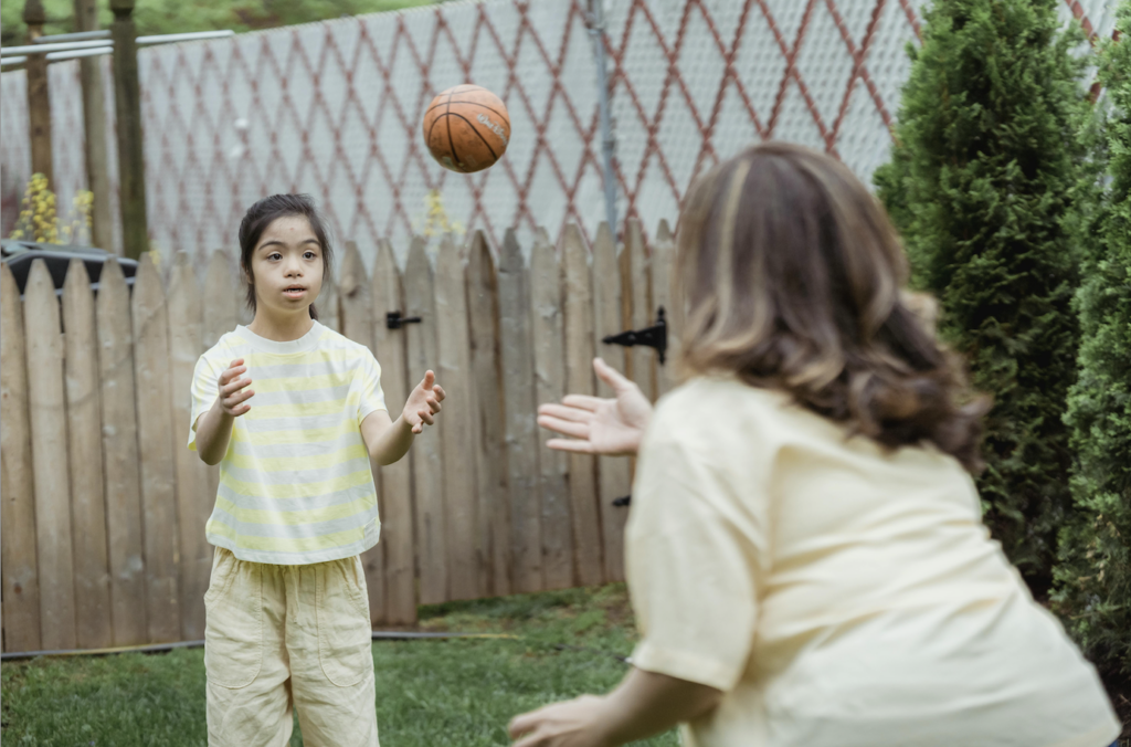 Family playing basketball inside of their Privacy Fence 